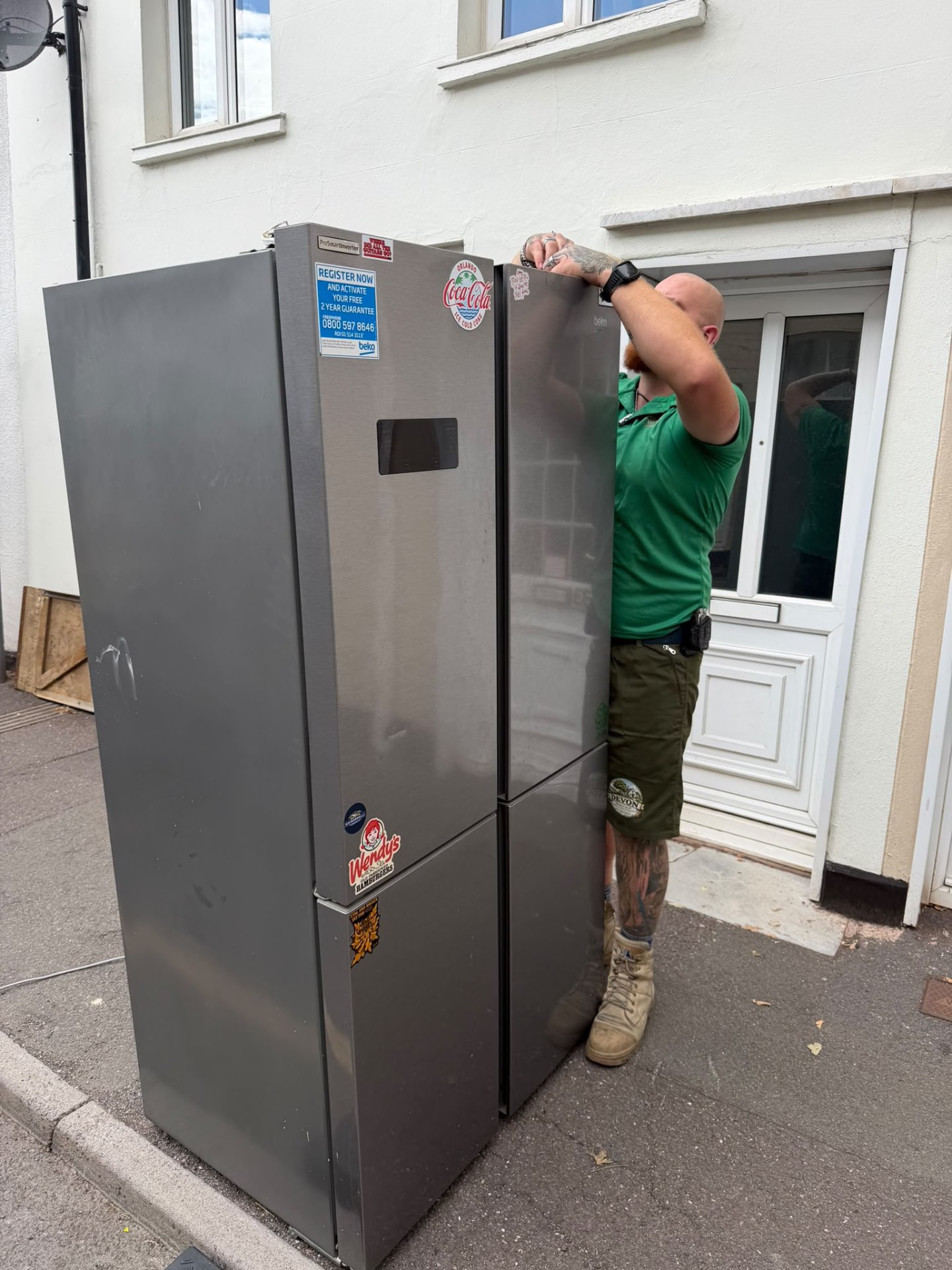 A Devon Heritage Removals team member carefully moving a large fridge freezer
